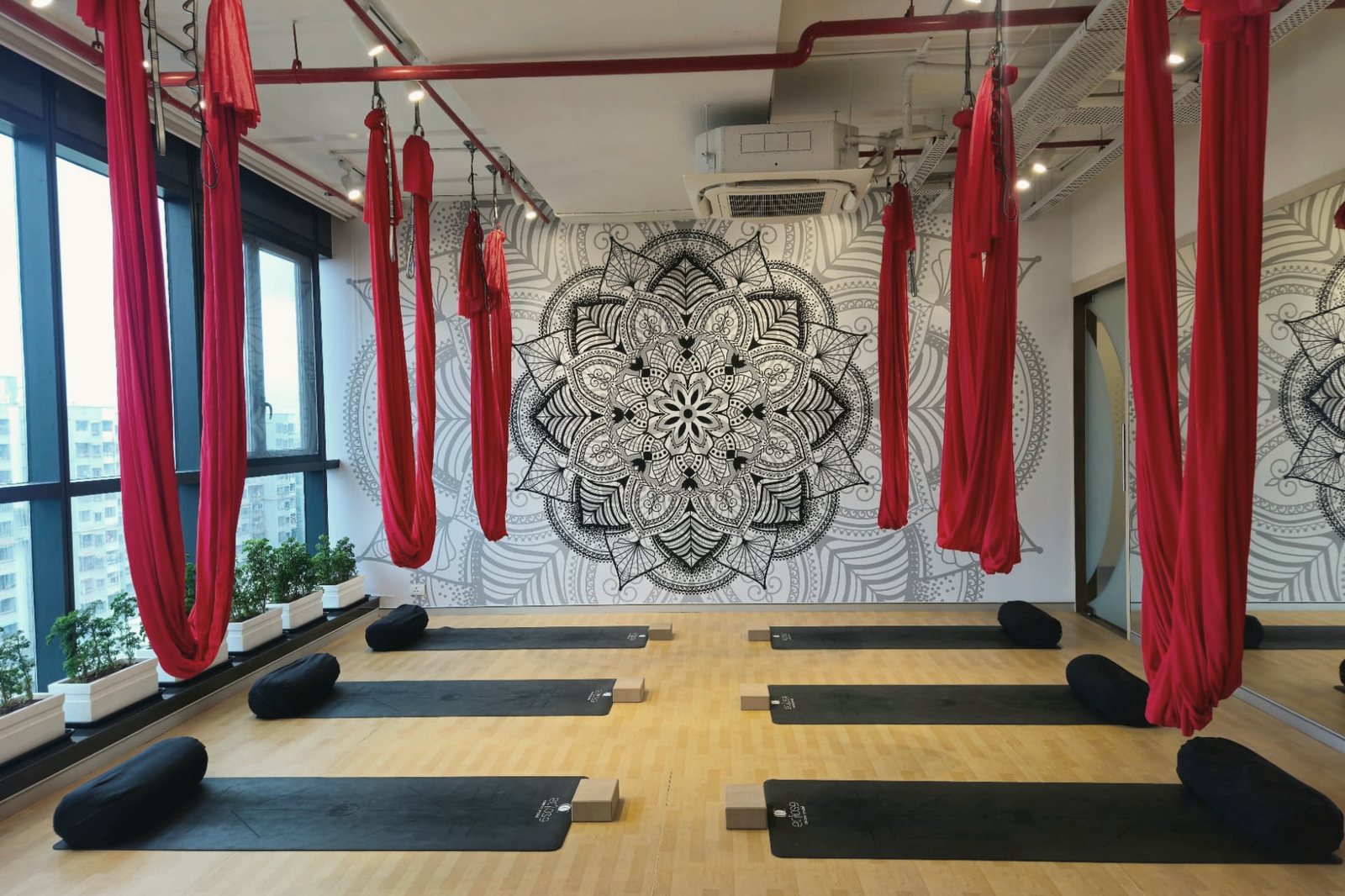 The Eclipse Wellbeing Hub studio, with mats laid out beneath a mandala mural